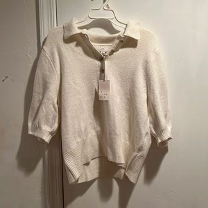 Cream sweater. Never worn. Quarter length selves. Colored button down V-neck.